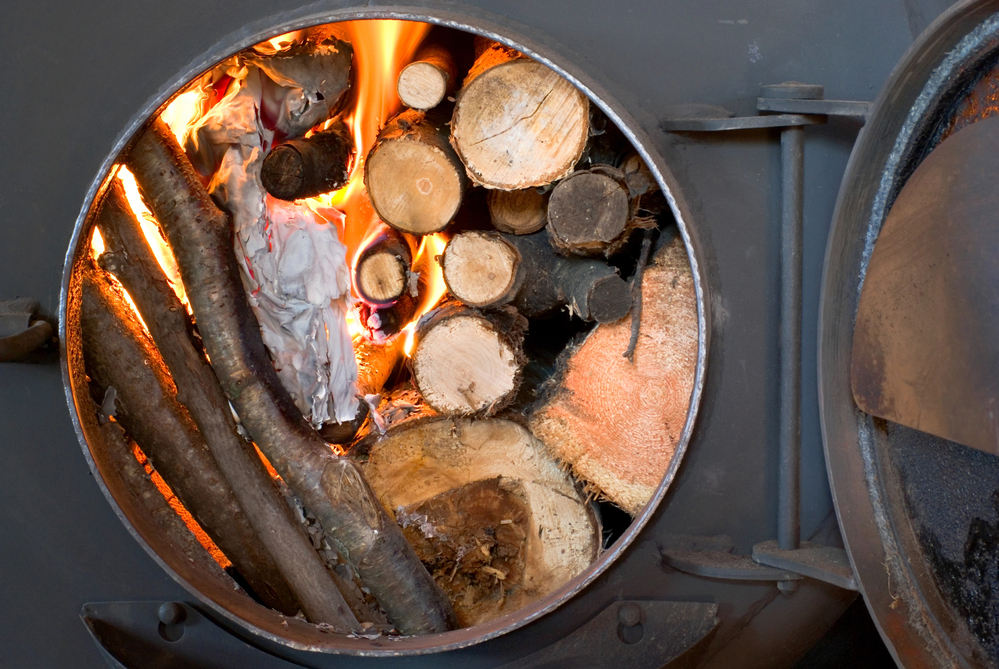 wood logs burning in a burner for heating