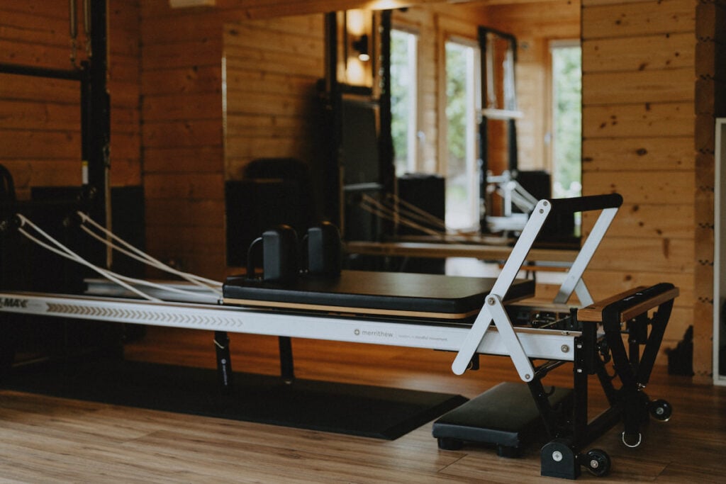 pilates reformer in a wooden garden room