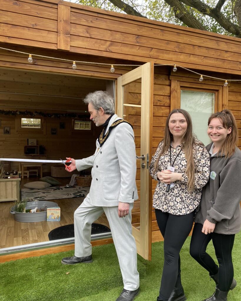 people standing in front of a log cabin