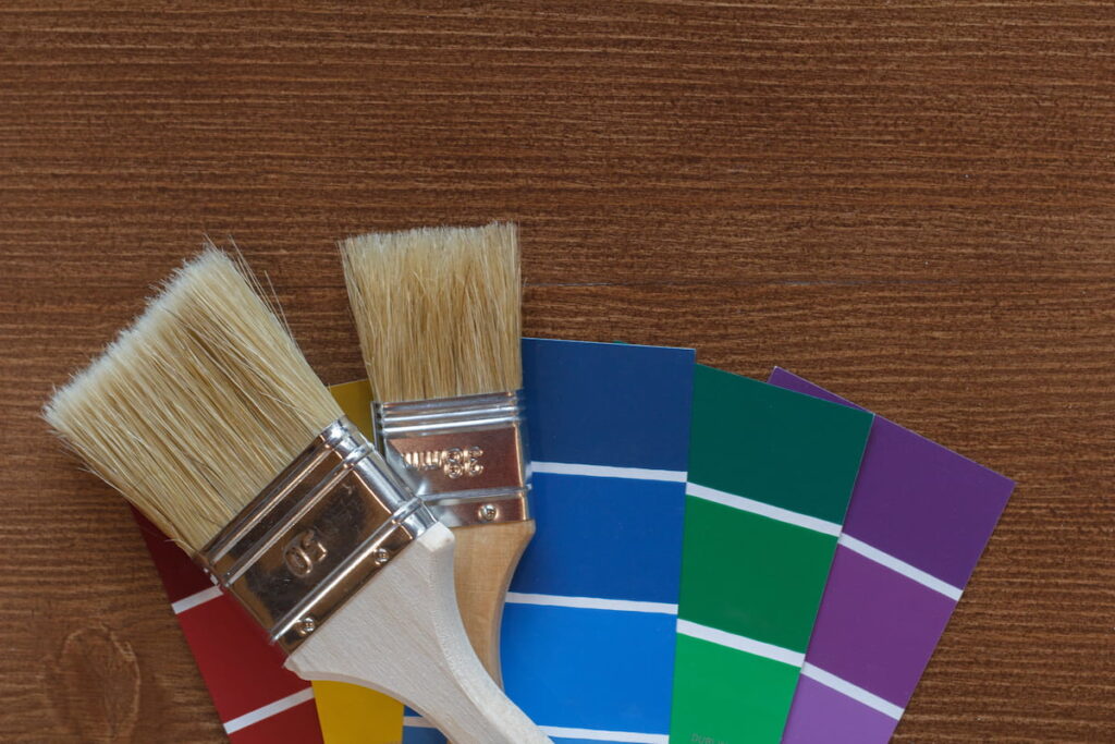 closeup of paint brushes and jewel tone paint swatches