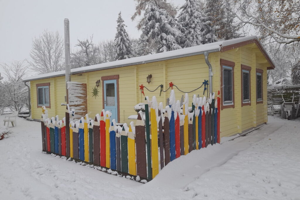 snowy yellow summer house exterior