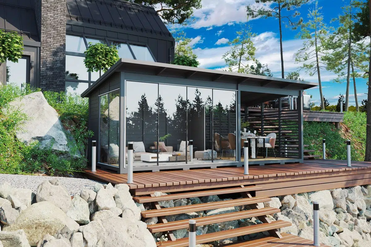 Modern grey garden house with glass wall and veranda