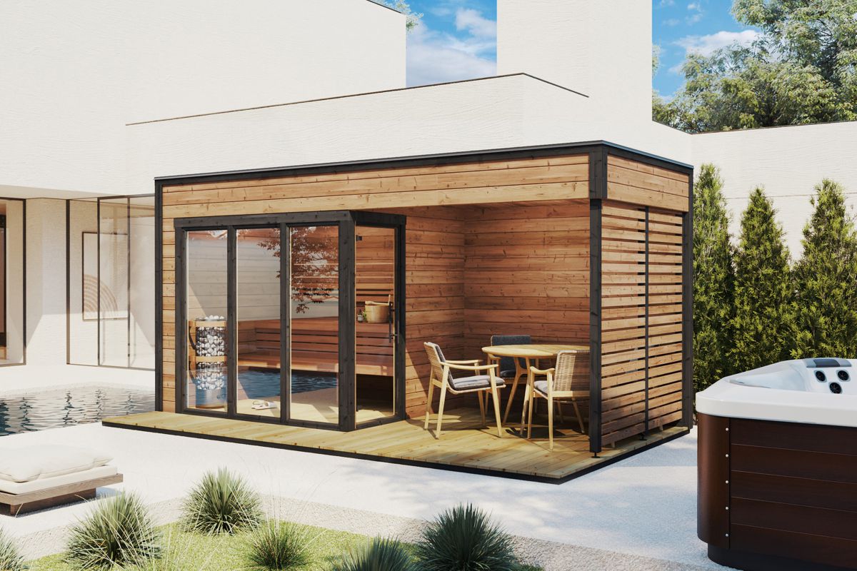 Modern outdoor sauna cabin with veranda in a garden. Made from thermowood.